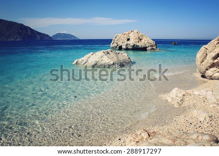 Calm blue sea and  rocks. Aged photo. Small island near Adrasan. Vintage effect image. Rocky shore. Toned photo. Antalya Province, Turkey. Wide photo for site slider.