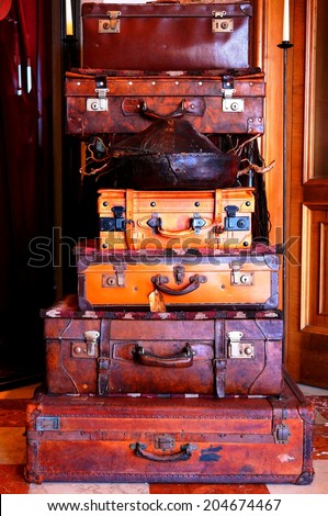 Pile of six vintage leather suitcases