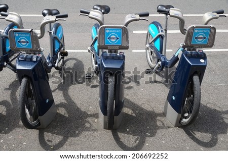 LONDON, ENGLAND - JULY 6, 2014 - Shared bikes are lined up in the streets of London. Barclays Cycle Hires, launched in July 2010, has over 720 stations and 10,000 bikes throughout London.