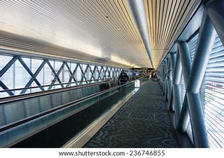 MIAMI, FLORIDA--1 OCTOBER 2014-- A TSA agent walks in a long corridor inside the Miami International Airport (MIA).