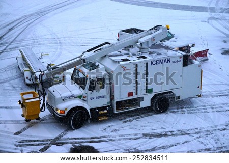 JOHN F. KENNEDY AIRPORT, NEW YORK 9 JANUARY 2015  de-icing truck is parked on the tarmac at John F. Kennedy International Airport (JFK) after a winter snowstorm.