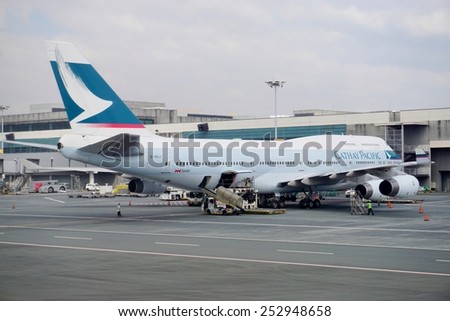MANILA, PHILIPPINES 12 JANUARY 2015-- A Boeing 747 jumbo jet airplane from Cathay Pacific (CX) gets ready at Manila\'s Ninoy Aquino International Airport (MNL).