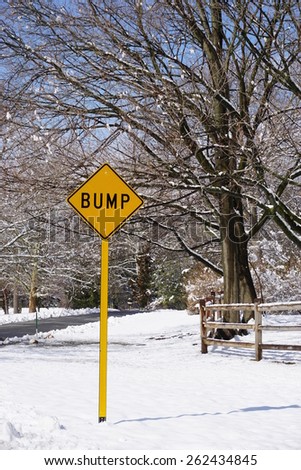 Yellow bump road sign in a snowy landscape