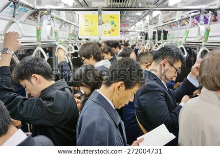 TOKYO, JAPAN -10 APRIL 2015- Commuters are packed inside a car in the Tokyo metro subway. The greater Tokyo metropolitan area has an extensive public transit system.