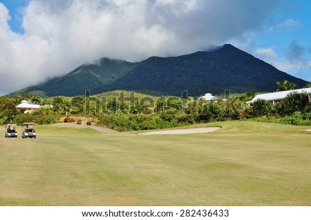 CHARLESTOWN, NEVIS -20 MAR 2014- The golf course at the luxury hotel Four Seasons Nevis is located at the foot of the Nevis Peak volcano in an old sugar mill plantation.