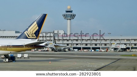 CHANGI, SINGAPORE -14 JANUARY 2014- The logo of a Singapore Airlines (SQ) plane as it gets ready for take-off at Singapore Changi Airport (SIN) with the control tower in the background.