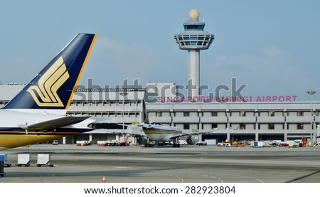 CHANGI, SINGAPORE -14 JANUARY 2014- The logo of a Singapore Airlines (SQ) plane as it gets ready for take-off at Singapore Changi Airport (SIN) with the control tower in the background.