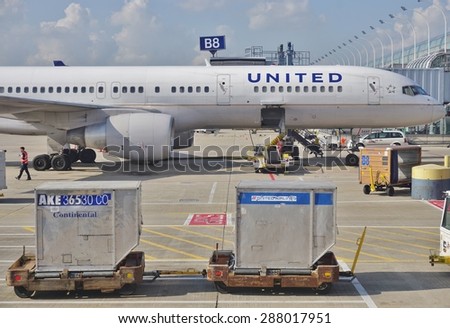 CHICAGO, IL -16 MAY 2015- Baggage containers marked Continental Airlines and United Airlines on the tarmac at Chicago OHare International Airport (ORD). The two companies fully merged in 2012.