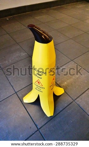 NEW YORK, NY -12 JUNE 2015- Whimsical banana shaped Caution Wet Floor sign in a fresh juice bar in New York City.