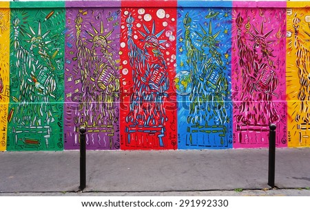 PARIS, FRANCE -20 JUNE 2015- The mural exhibit Art Liberte du Mur de Berlin au Street Art lines the rue de Alsace street in the 10th arrondissement of Paris near the Gare de Est railway station.