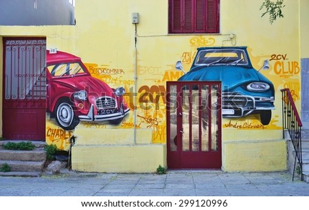 ATHENS, GREECE -14 JULY 2015: Wall paintings of Citroen cars on the walls of the building hosting the Citroen Club of Greece in Athens.