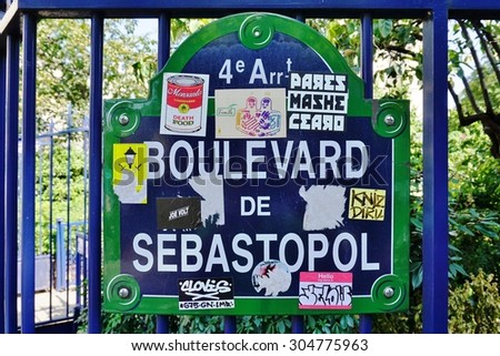 PARIS, FRANCE -8 JULY 2015- Street sign covered with stickers for the Boulevard de Sebastopol in the 4th arrondissement of the French capital.
