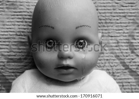 Close up of doll face with tear