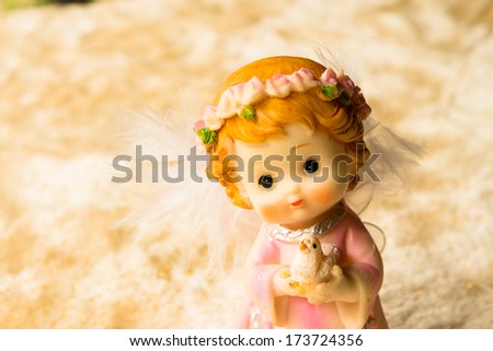 Angel dolls on carpet background to play to god