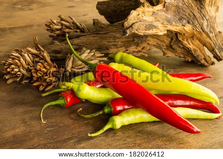 Still lift with hot chili peppers on old wooden table