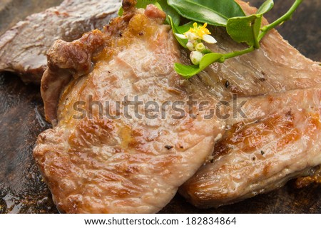 Grilled steaks,Cooked Pork Roast with Vegetables and Spices on wood