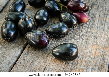 Jambolan plum, Java plum, Jambul( Syzygium cumini (L.) Skeels. on wooden background