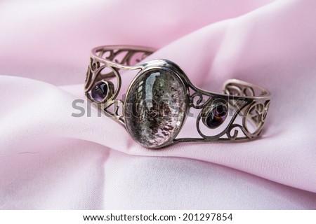 Costume Jewelry. silver,Vintage female bracelet on pink background