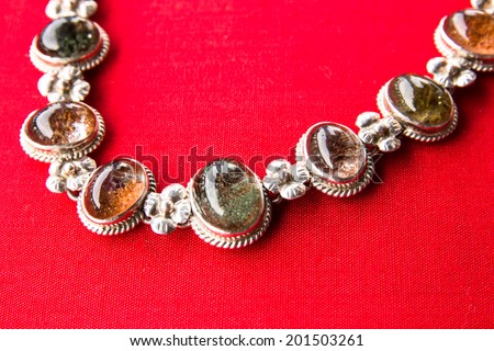 Costume Jewelry. silver,Vintage female bracelet on red background