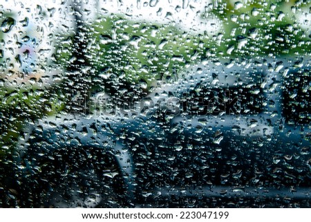 Rainy day ,looking through rain drops on a car window blurry vision