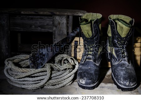 Still life art photography old boots on wooden table over grunge