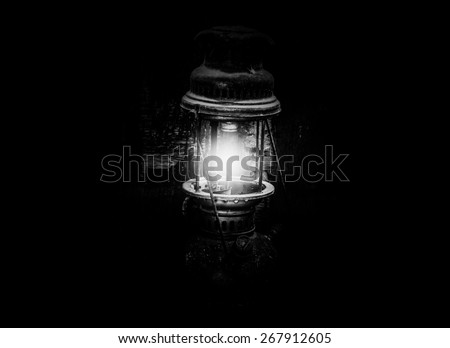 Still life with old lamp on wood,Light lamp in dark black and white photo