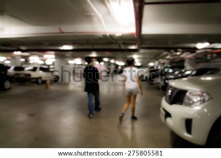 Man and woman in  parking area on blur