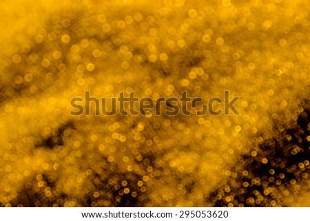Abstract bokeh background from gold fabric ,sparkle glitter for design,blurry