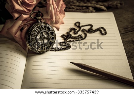 Vintage pocket watch pencil and roses on note book time concept,Vintage filter effect