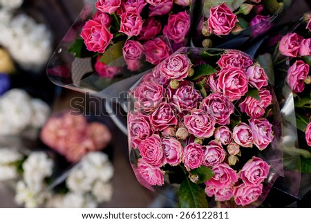 Beautiful pink rose bouquets fir sale on the street market, view from above