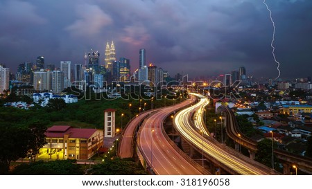 KUALA LUMPUR, MALAYSIA - 13TH JANUARY 2014; Dramatic scenery of elevated highway heading towards Kuala Lumpur city centre during sunset.