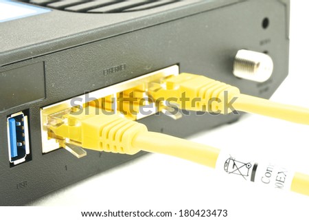 Cable modem router have yellow lan cable connected to port.