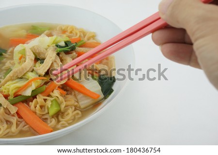 Egg noodle and clear soup vegetarian for health. It include vegan protein dry, carrot, kale and cabbage on white background.