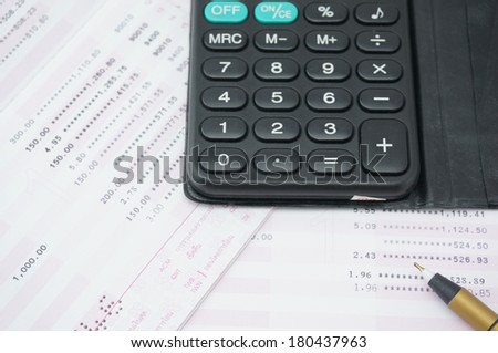 Calculator put on the pink and white bank account. For calculating the interest rate.