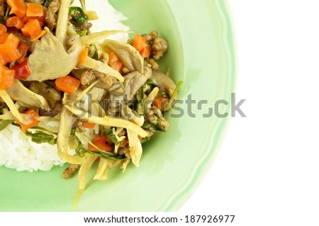 Close up carrot fried with oyster mushroom, vegan protein and basil on rice isolated white background.