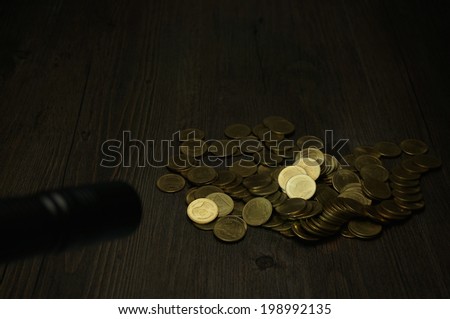 Use flashlight to find hair on pile of gold coins at night.