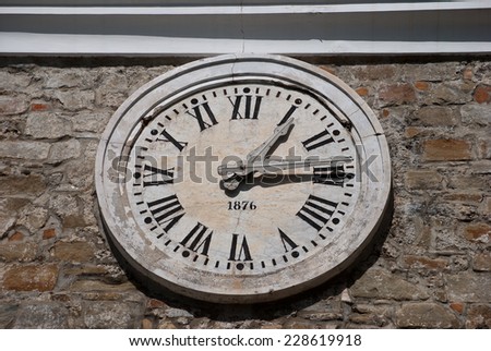 Old stone clock with roman numerals