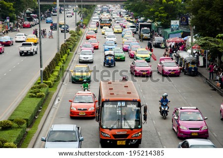 BANGKOK, THAILAND - MARCH 11, 2012: Colorful taxis of the capital fill the streets near Chatuchak. The latter is one of the biggest open air markets in the world.