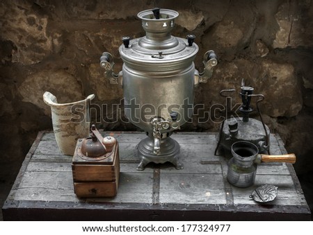 old samovar, coffee grinder, oil lamp, coffee maker on a table