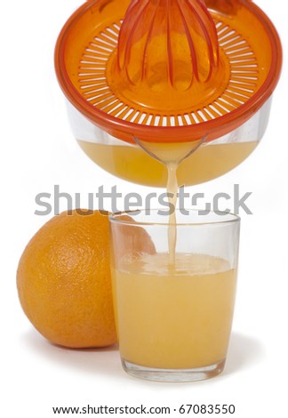 Orange juice, pouring orange juice from a juicer in the glass