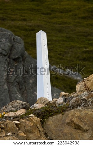 Cairn marking the international border between Canada and the United States. White Pass, north of Skagway, Alaska.