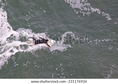 SAN FRANCISCO, CA, USA - APRIL 2010: Aerial View of surfer in wet suit preparing to ride a wave, San Francisco Bay, California, USA