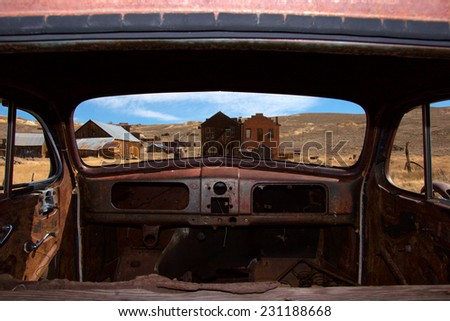 Unique vantage point looking out to ghost town of Bodie, California from inside of abandoned car
