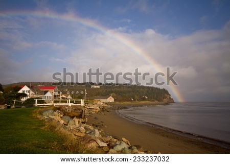 Spectacular rainbow goes into the bay over the village of Alma, New Brunswick, Canada