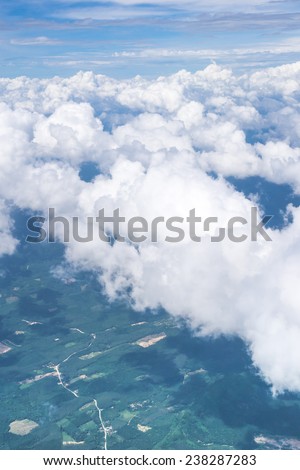white cloud ,clear blue sky and green earth view from airplane