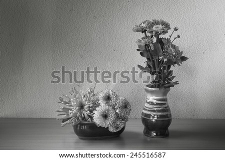 Still life with flower on wooden table on black and white