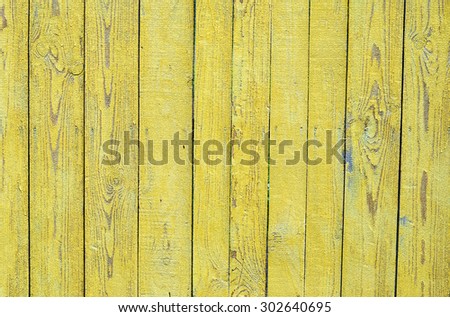 Grungy wood planks wall texture with yellow peeling paint
