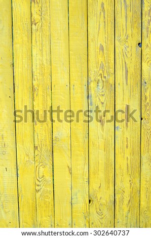 Grungy wood planks wall texture with yellow peeling paint