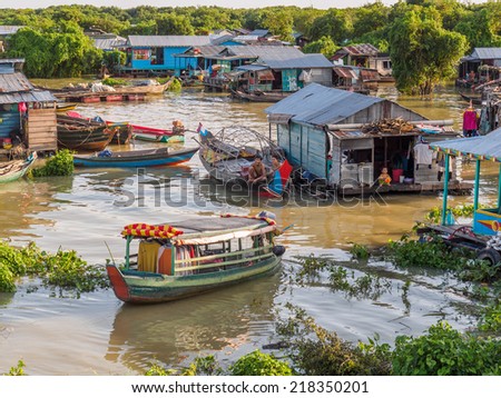 TONLE SAP, CAMBODIA - AUGUST 12, 2014: Unidentified people go about their daily life in floating village on Tonle Sap lake. It is the largest lake in Southeast Asia (up to 16,000 square km).