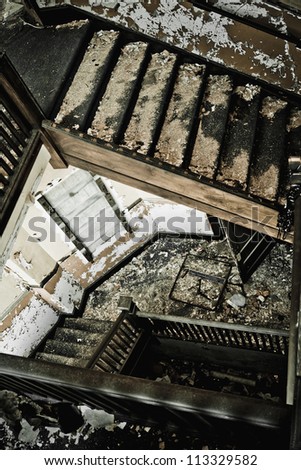 Stairway in an abandoned building, looking down the stairs.